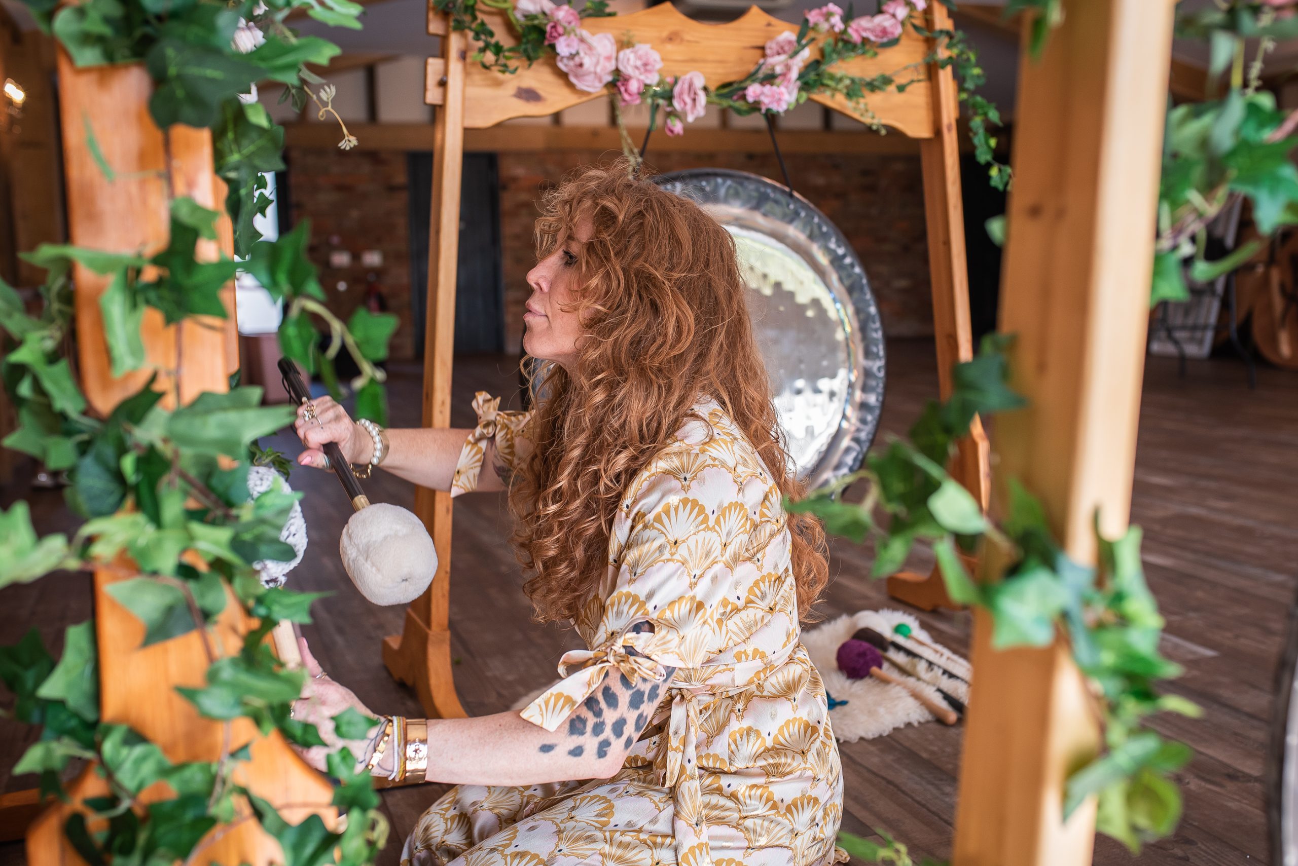 TANIA WITH CEREMONIAL GONGS. PENZANCE, CORNWALL